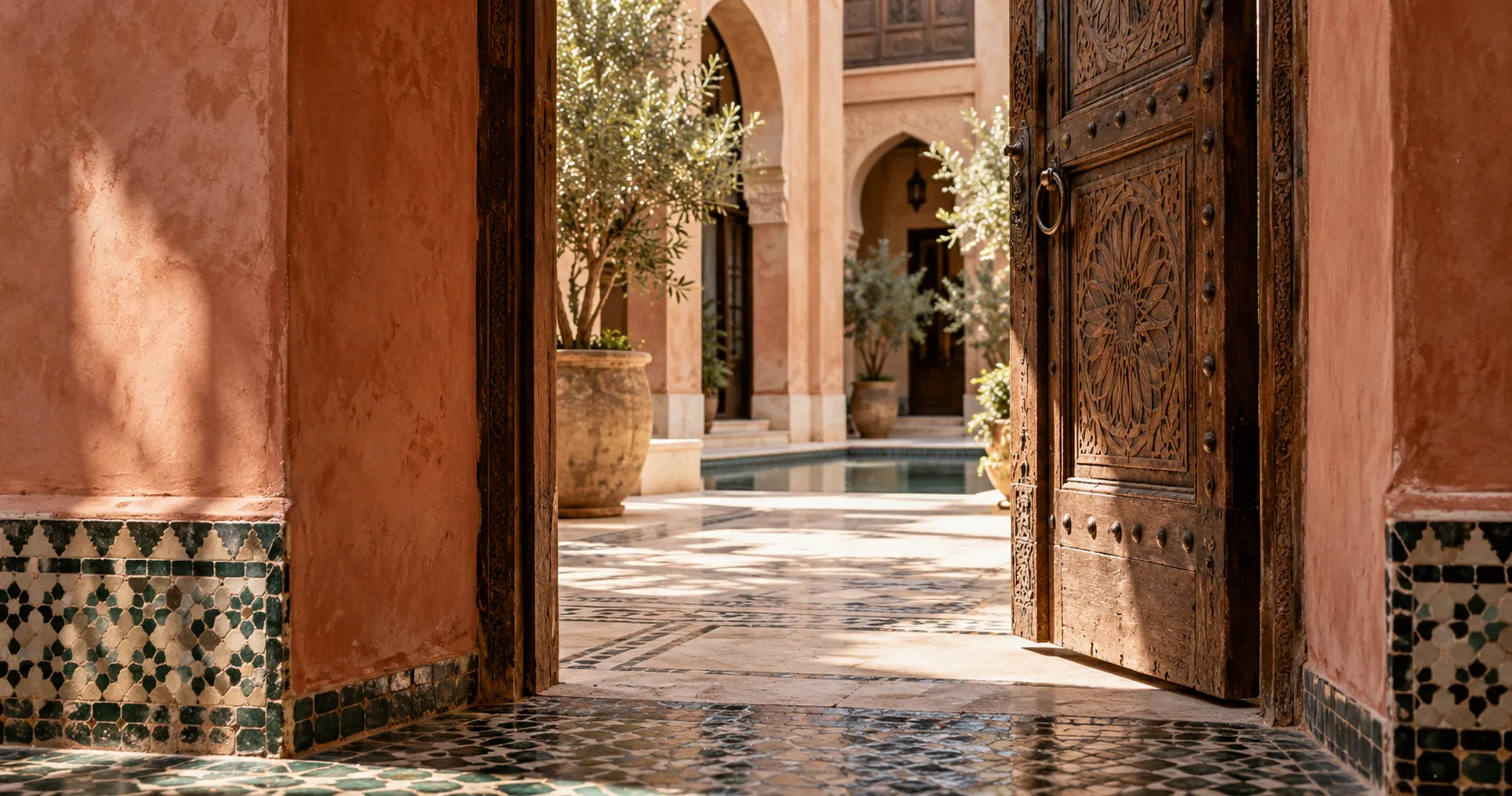Carved doorway opening onto a Marrakech courtyard